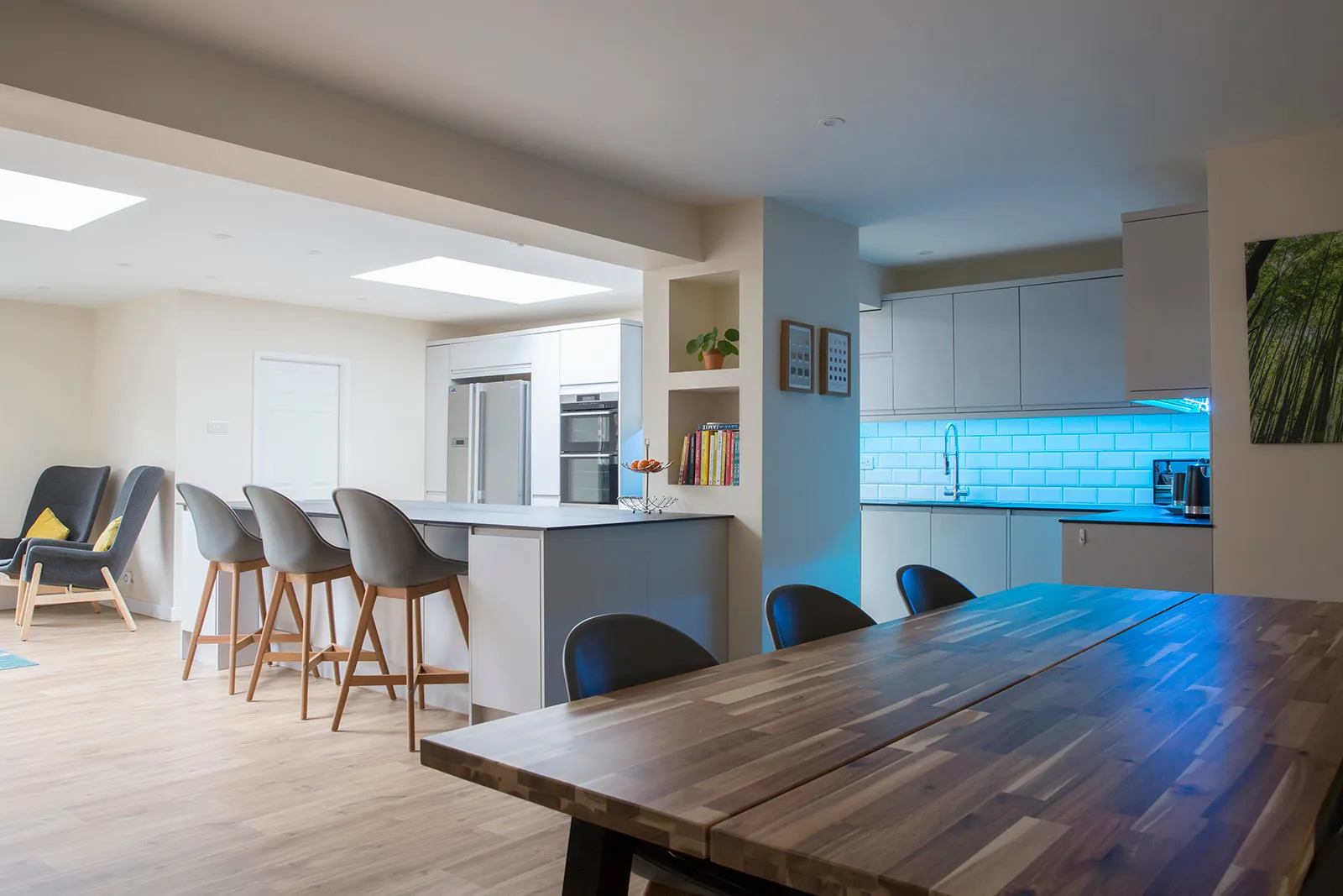 A kitchen with a wooden table and chairs.